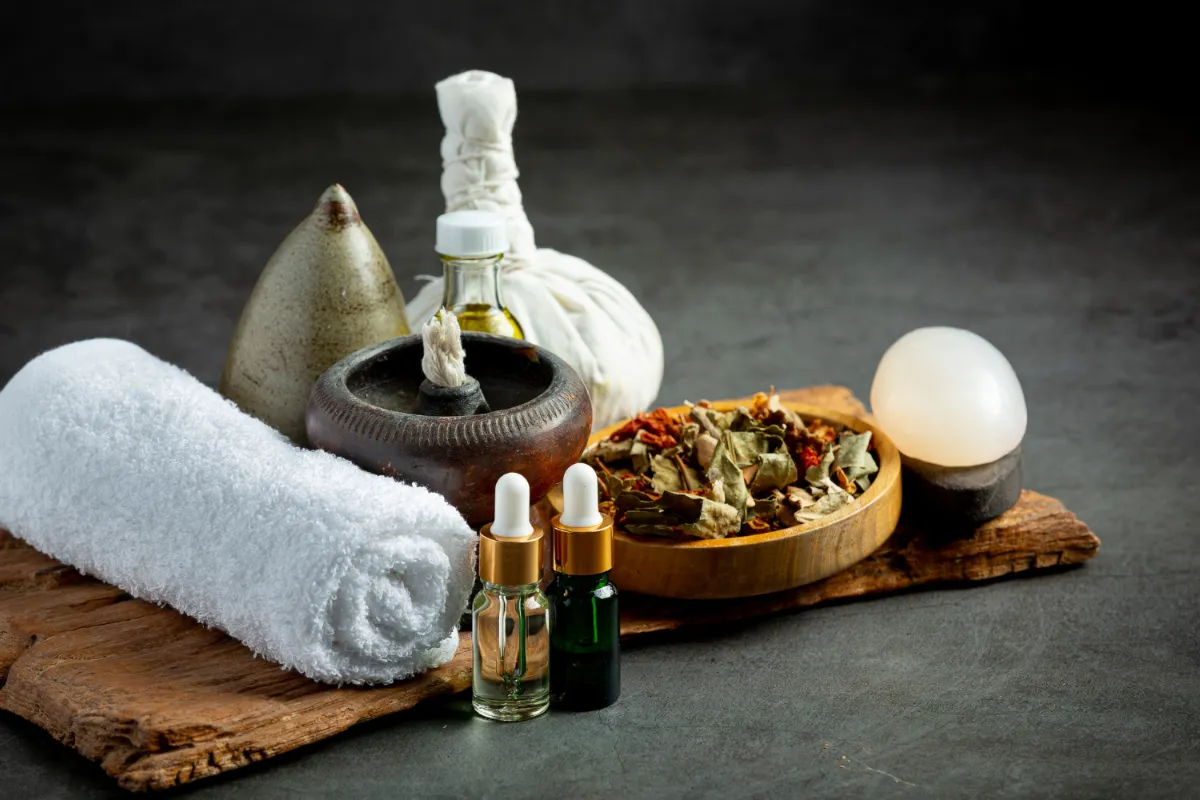 Ayurvedic herbal oils, bolus pouch, and traditional wellness items arranged for Panchakarma therapy</p>
<p>
