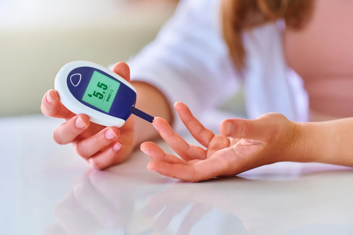Checking blood glucose level, highlighting Ayurvedic support for diabetes and metabolic balance