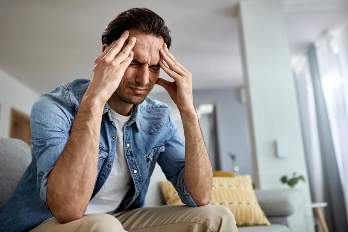 Man experiencing migraine representing Ayurvedic Panchakarma therapy for long-term headache relief